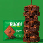 RUANI Decadent Coffee functional brownie stack with chocolate-espresso drizzle and coffee beans beside the product pack