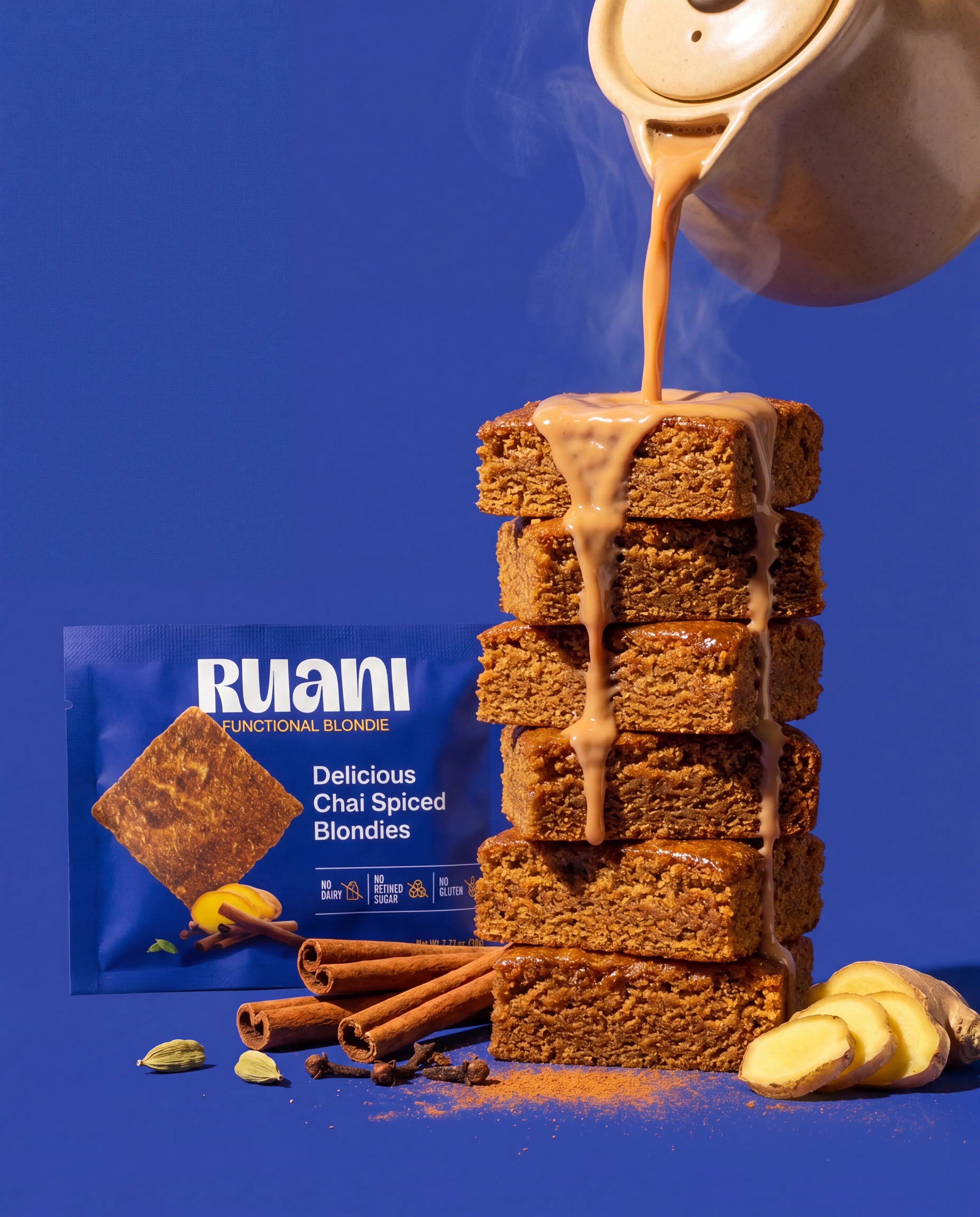 RUANI Delicious Chai Spiced Blondie stack with chai poured from a kettle beside the product pack